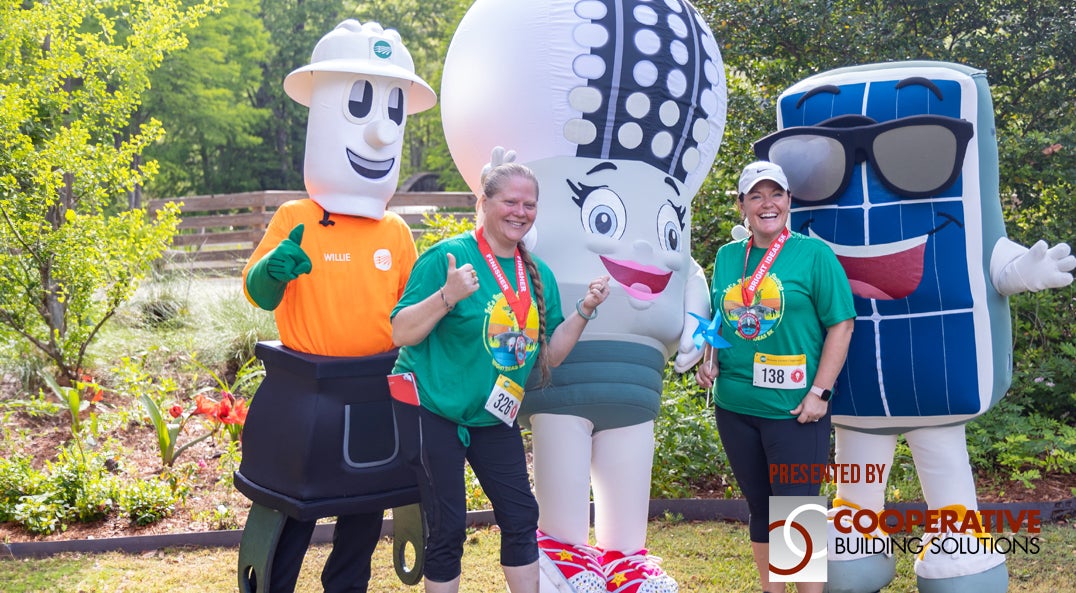 race participants posing with mascots
