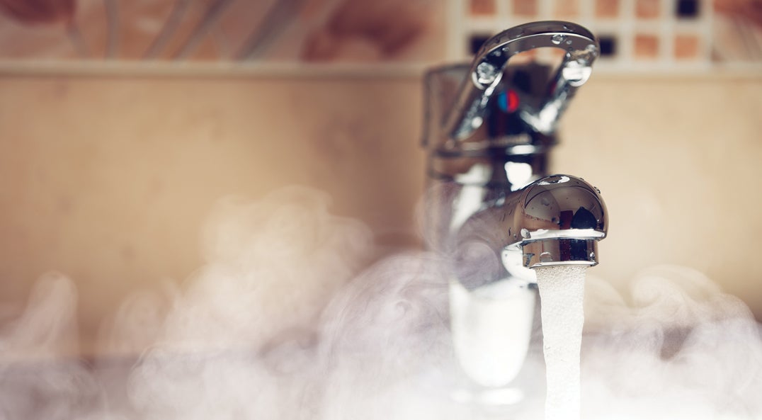 bathroom faucet running hot water with steam