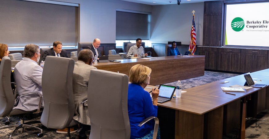 trustees seated around board room table