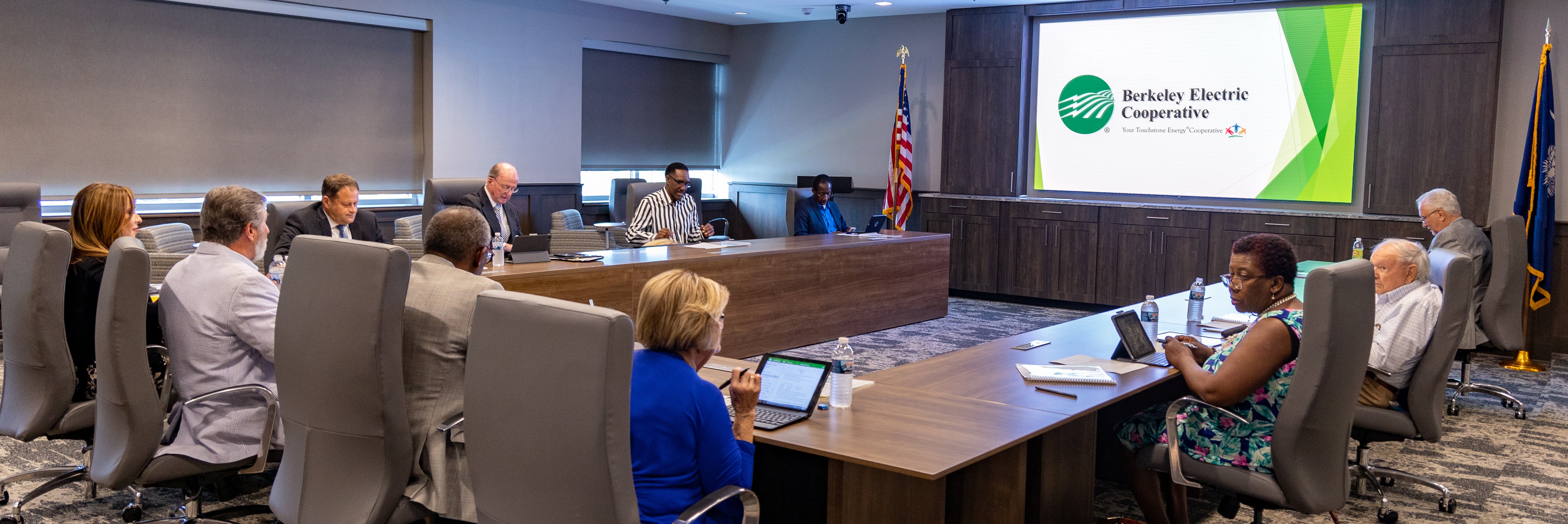Board of trustees sitting at table in board room